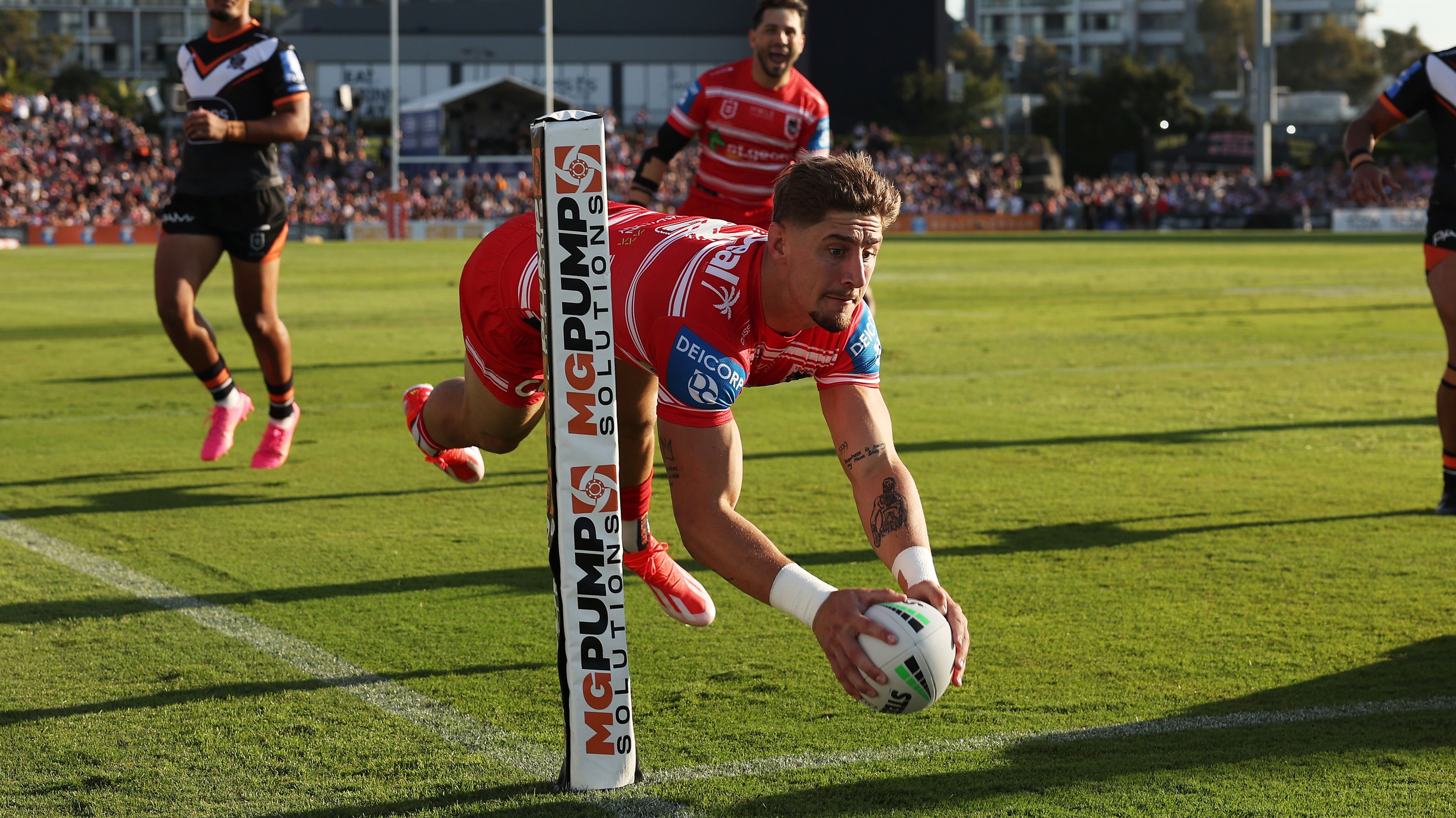 Zac Lomax scores a try during the round six NRL match between the Wests Tigers and the St George Illawarra Dragons.