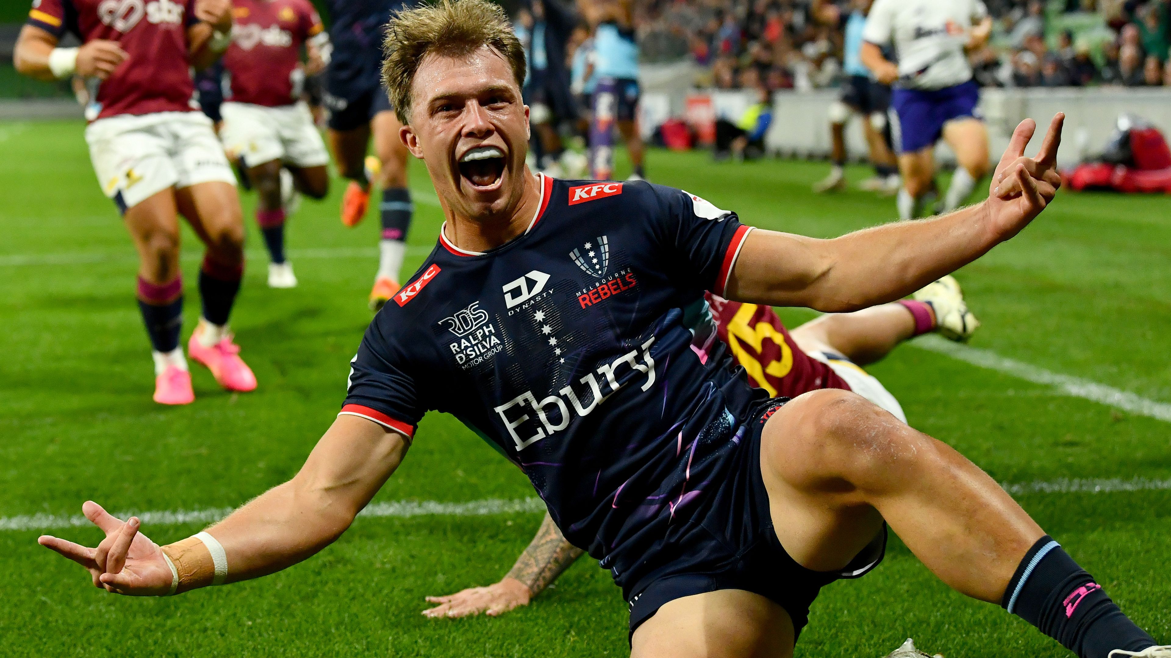 Darby Lancaster of the Rebels celebrates scoring a try.