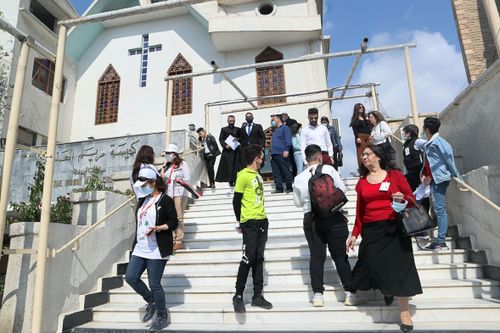 Iraqi Christians gather at the Church of the Virgin Mary before going to the airport to welcome the Pope in Baghdad, Iraq, Friday, March 5, 2021