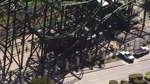Workers at Movie World's Green Lantern ride today. (9NEWS)
