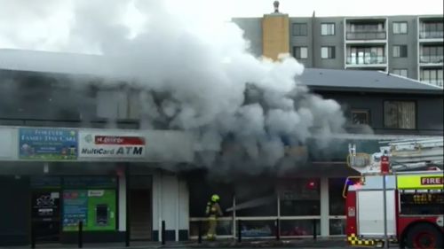 Man rescues five people from units above burning Sydney dollar shop