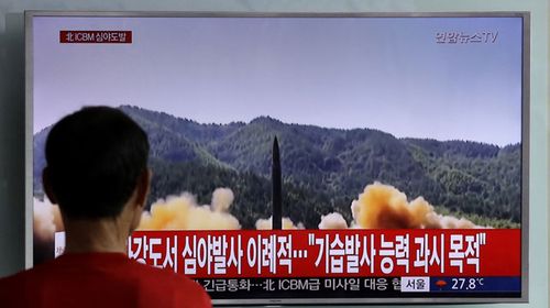 A South Korean watches file vision of a North Korean missile launch. (AAP)