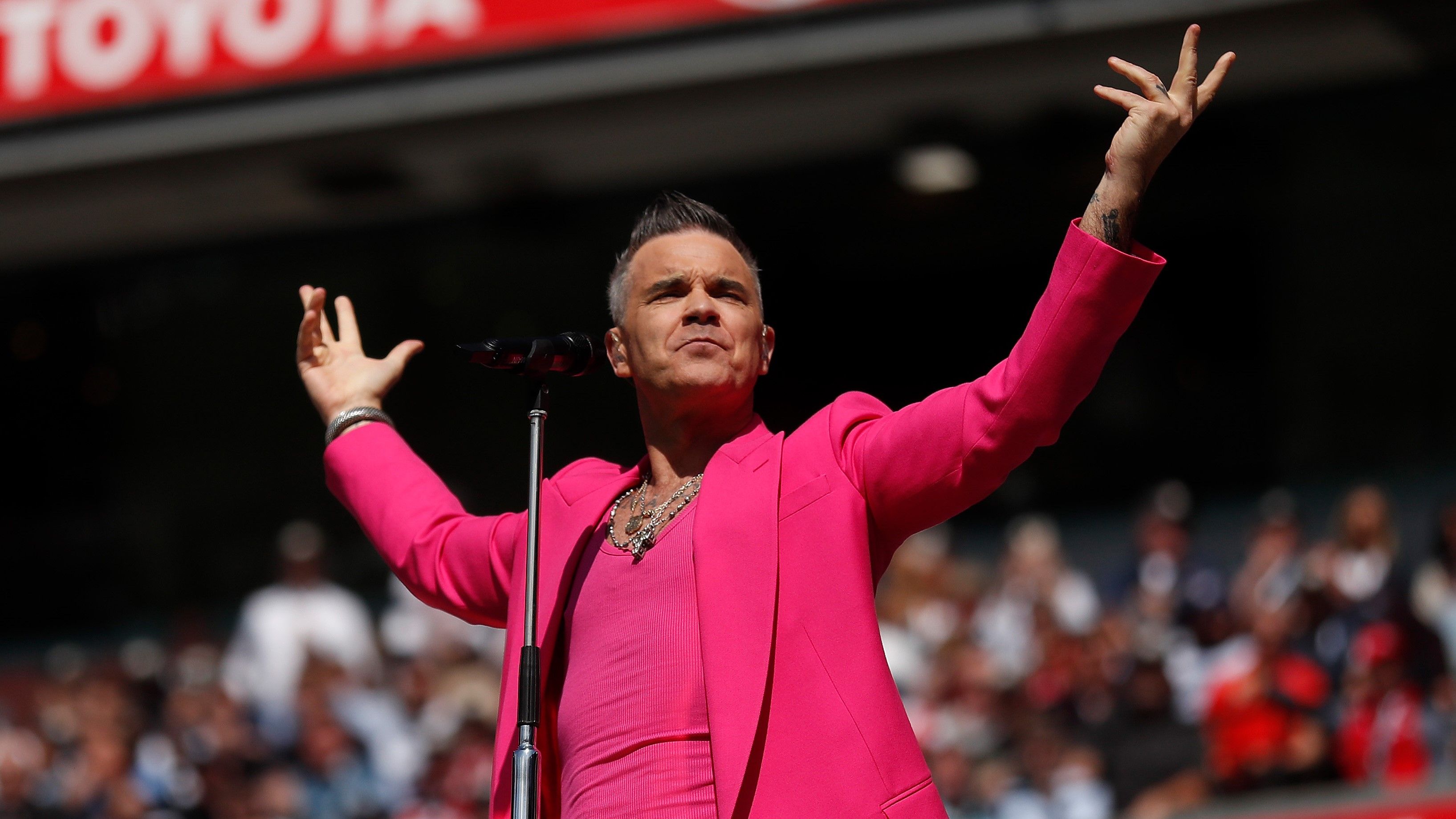 Robbie Williams performs during the 2022 AFL Grand Final match between the Geelong Cats and the Sydney Swans at the Melbourne Cricket Ground.