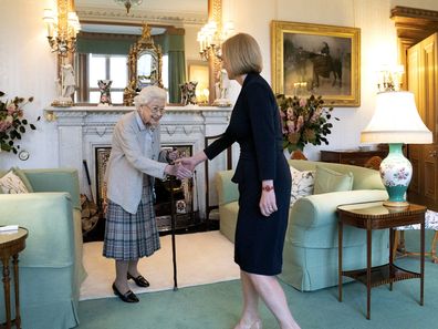 Queen Elizabeth II, left, welcomes Liz Truss during an audience at Balmoral, Scotland, where she invited the newly elected leader of the Conservative party to become Prime Minister and form a new government, Tuesday, September 6, 2022.
