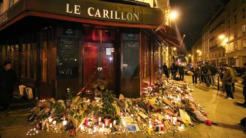 Mourners have left flowers outside the Le Carillon theatre, one of the restaurants attacked by terrorists. (Getty) 