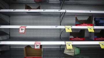 Empty shelves and freezer sections at Woolworths.