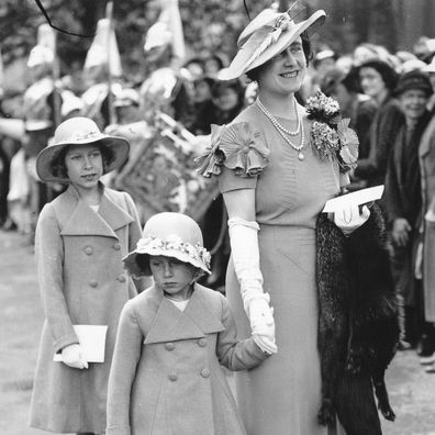 A young Princess Elizabeth (later Queen Elizabeth) and Princess Margaret with their mother in March 1935. 