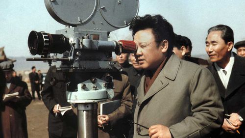 Kim Jong-il looks into a film camera in 1979. (AP)