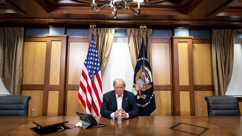 Mr Trump is framed by both the US flag and America's presidential flag during the phone call.