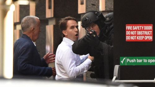 Mr O'Brien (in the blue blazer) and another hostage sprint to freedom. (Getty Images)