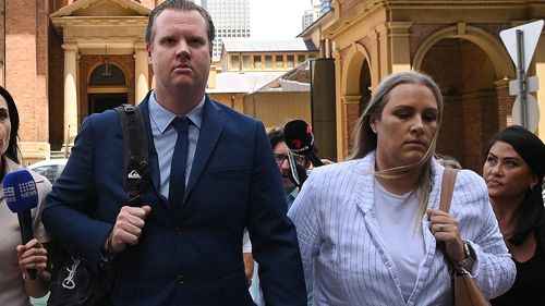 Senior Constable Christian White (centre) leaves the NSW Supreme Court in Sydney with his fiance (2nd right) after being found guilty by a jury of the manslaughter of 95-year-old Claire Nowland, who he electrocuted at a nursing home home in Cooma. Sydney, New South Wales. November 27, 2024 Photo: Kate Geraghty