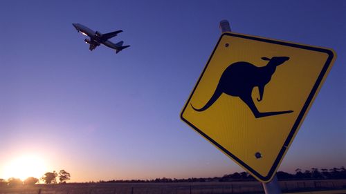 A plane takes off from a rural Australian airport.