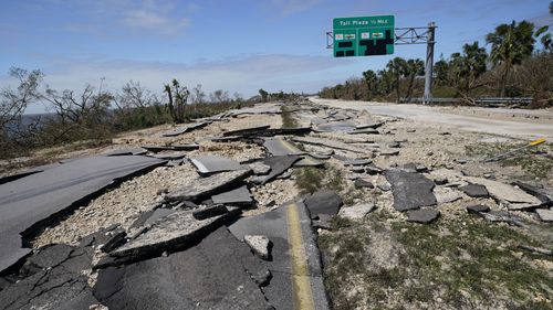 Broken pavement lies flat leading to the Sanibel Island causeway in the aftermath of Hurricane Ian, Thursday, Sept. 29, 2022, in Fort Myers, Fla. (AP Photo/Steve Helber)