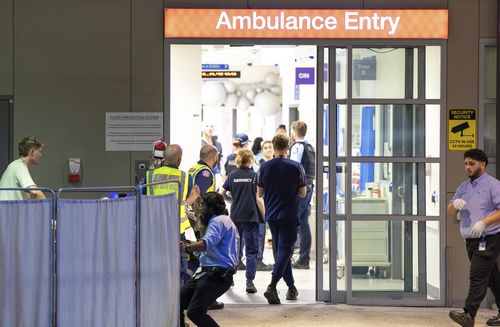 A patient is taken to St Vincent's Hospital in Darlinghurst following a mass shooting in Bondi.