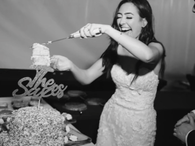 Laura Saxe cutting her homemade wedding cake on her big day.