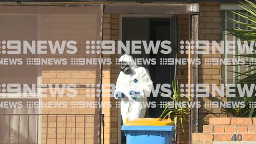 Police wore hazmat gear as they scoured the suspect's Shepparton home this morning.