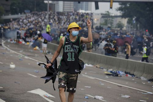 A protester gestures after clashes with riot police during a massive demonstration outside the Legislative Council in Hong Kong.