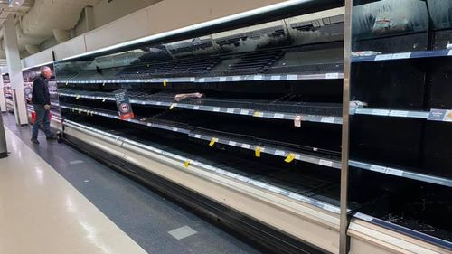 North Richmond supermarket shelves stripped bare as the community is cut off by floodwaters.