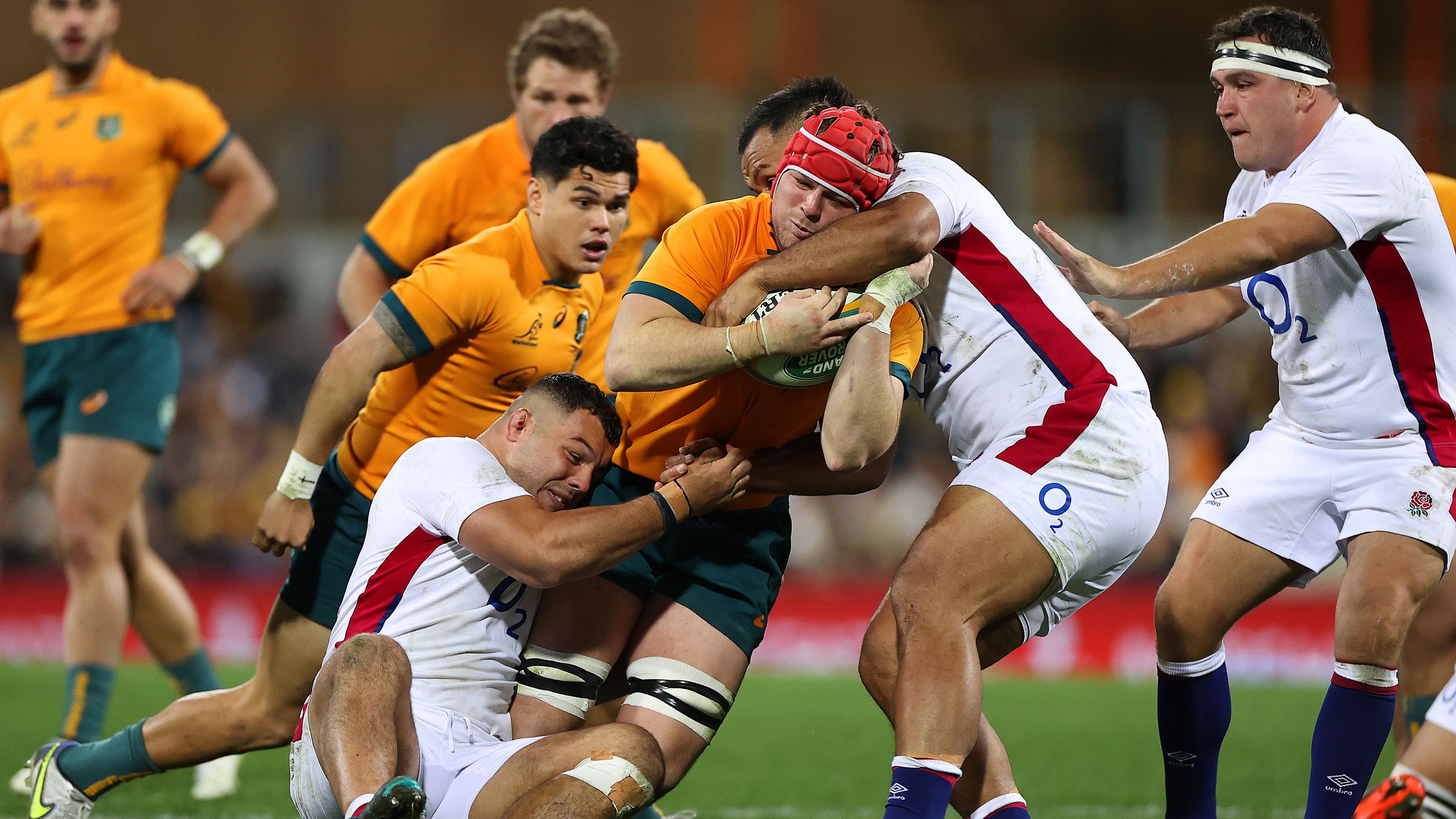 Harry Wilson of the Wallabies is tackled by a member of the England rugby team.
