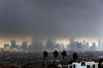 Thick heavy smoke from wildfires shrouds downtown Los Angeles on Wednesday, Jan. 8, 2025. (AP Photo/Richard Vogel)