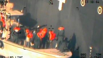This image released by the US Department of Defence, taken from a US Navy helicopter, shows what the Navy says are members of the Islamic Revolutionary Guard Corps Navy removing an unexploded limpet mine from the M/T Kokuka Courageous. 