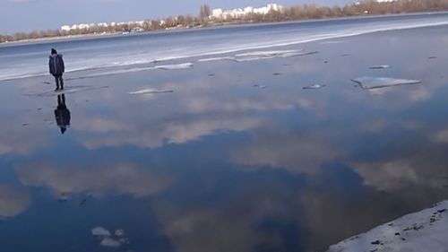 The boy was floating on a thin sheet of ice in Kyiv.