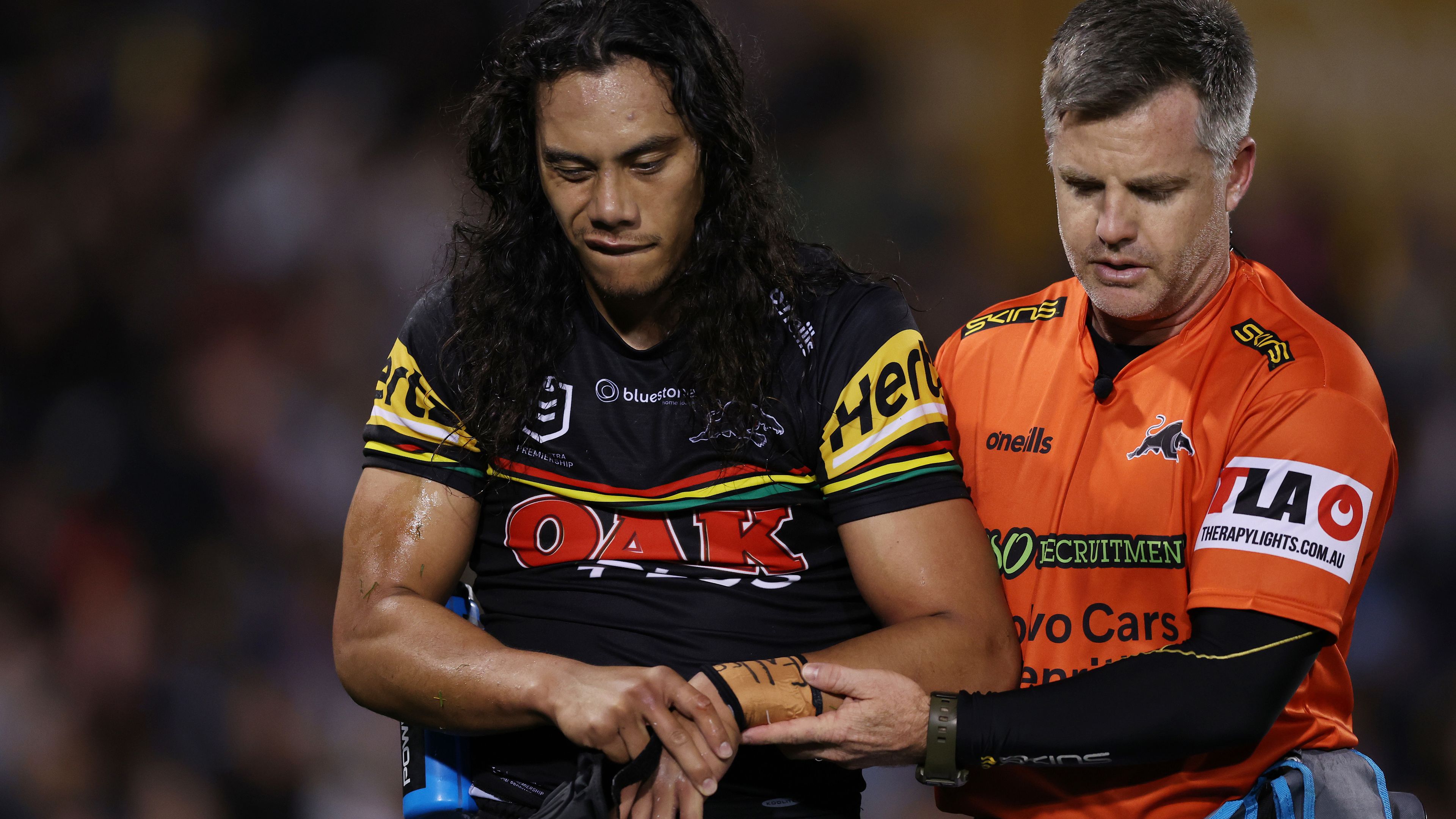 Jerome Luai of the Panthers is assisted from the field after sustaining an injury during the round 26 NRL match between Penrith Panthers and Parramatta Eels at BlueBet Stadium on August 24, 2023 in Penrith, Australia. (Photo by Mark Metcalfe/Getty Images)