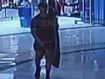 CCTV of Beau Lamarre-Condon walking out of a shop with a surfboard bag.