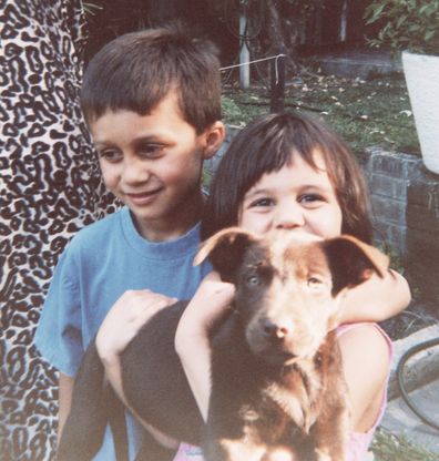 A young Turia Pitt with her brother and pup