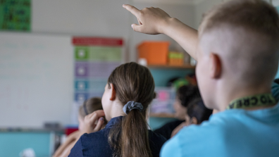 Children sit for the first day of classes of the new school year at the GuthsMuths elementary school during the coronavirus pandemic on August 10, 2020 in Berlin, Germany. 