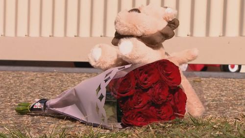 A one-year-old boy has died after he was run over by a reversing car while playing in the driveway of a home north of Brisbane. Flowers and a stuffed bear were left in the driveway of the home in the aftermath of the incident.