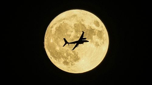 Aknc unmanned aerial craft passing in front of the Supermoon during a demonstration flight on the first day of Teknofest technology and aerospace festival in Ankara, Turkey, Wednesday, Aug. 30, 2023.