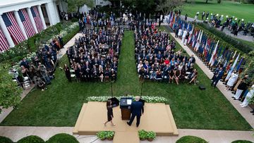 Judge Amy Coney Barrett walks to the microphone after President Donald Trump, right, announced Barrett as his nominee to the Supreme Court, in the Rose Garden at the White House, Saturday, Sept. 26, 2020, in Washington.