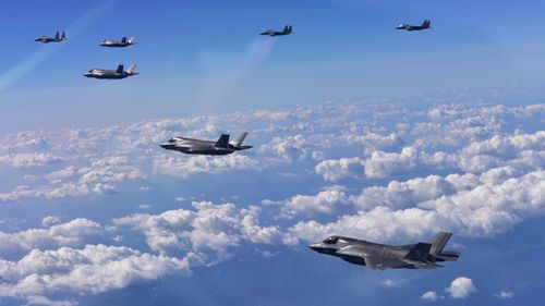 A photo provided by South Korean Defence Ministry in Seoul shows South Korean F-15K fighter jets and US F-35B stealth jet fighters flying over South Korea during a joint military drill aimed to counter North Korea’s latest missile test. (AFP)