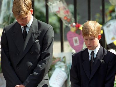 Prince William (left) and Prince Harry, the sons of Diana, Princess of Wales, bow their heads as their mother's coffin is taken out of Westminster Abbey following her funeral service. 