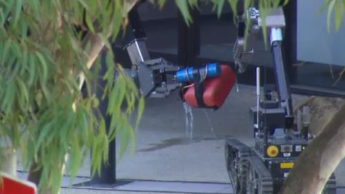 Two police robots were used to inspect the object, which turned out to be an inert hoax. (9NEWS)