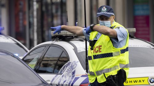 Police setup a road block to check road users identification on Enmore Road, Sydney.