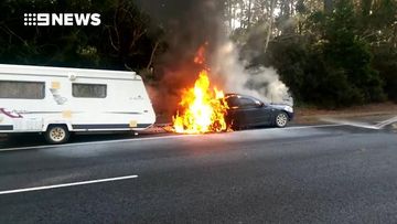Elderly couple alerted moments before their car burst into flames