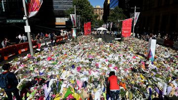 Sydneysiders continue to lay flowers at a memorial site near the Lindt cafe in Martin Place, (AAP)