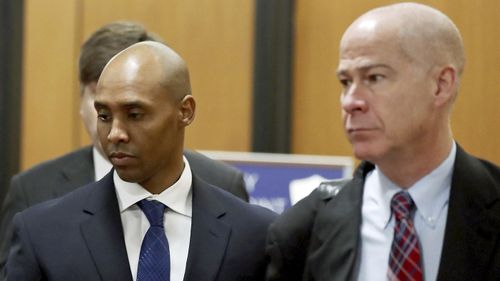 Former Minneapolis police officer Mohamed Noor, center, is accompanied by his attorneys Peter Wold, not pictured, and Thomas Plunkett, right, as he walks towards the Hennepin County Government Center for opening arguments of his trial.