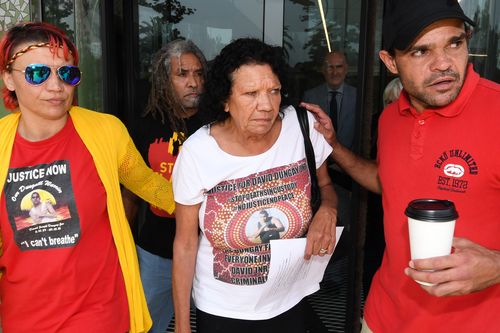 David Dungay's mother Leetona Dungay is led from the court by family and friends outside the Lidcombe Coroner's Court in Sydney.