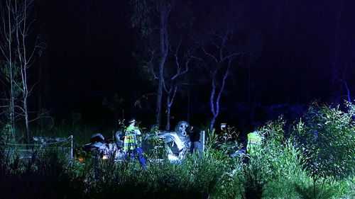 A vehicle with three people inside had been travelling south when it left the road, crashed through a fence and rolled.
