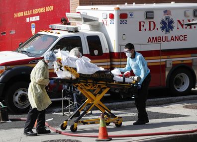 A patient is transferred from Elmhurst Hospital Center to a waiting ambulance during the current coronavirus outbreak, Tuesday, April 7, 2020, in New York