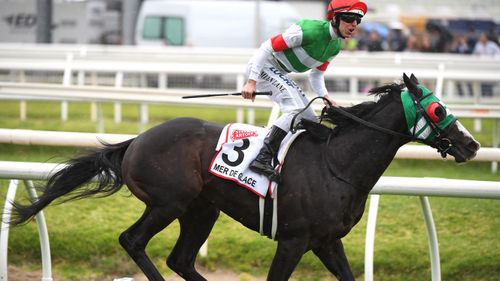 Jockey Damian Lane rides Mer De Glace to victory in Caufield Cup