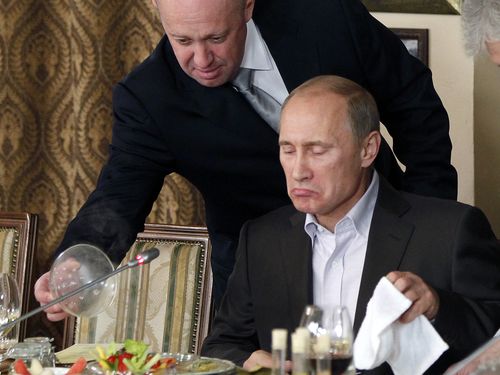 Yevgeny Prigozhin serves food to then-Russian Prime Minister Vladimir Putin at Prigozhin's restaurant outside Moscow, Russia during 2011.