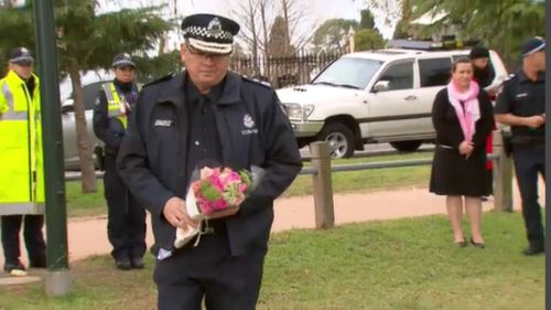 Chief Commissioner Graham Ashton has laid flowers at the memorial. (9NEWS)