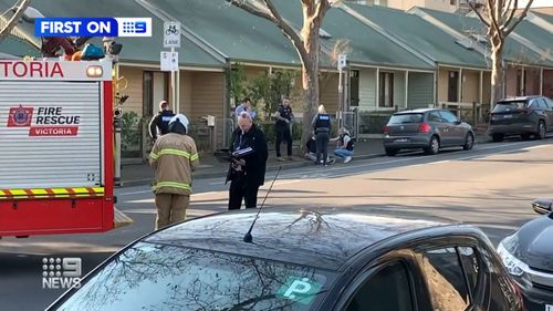 A former racehorse trainer is under police guard in hospital following a double stabbing in Melbourne's north on Monday night.