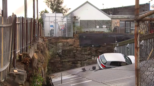 The car crashed into the roof of Raffan, Kelaher and Thomas Auctioneers in Leichhardt this afternoon.