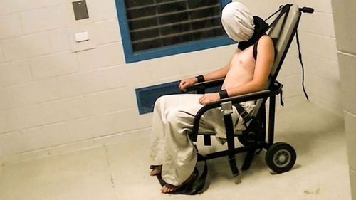 Dylan Voller is seen restrained, wearing a spit hood, in the Don Dale Youth Detention Centre. (Four Corners)