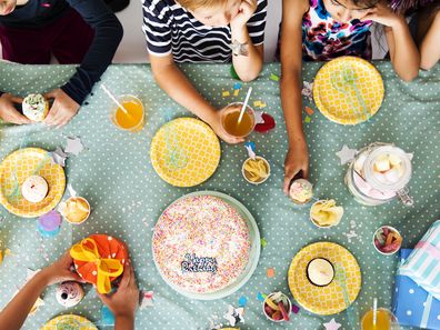 birthday cake and other beverage placed on table